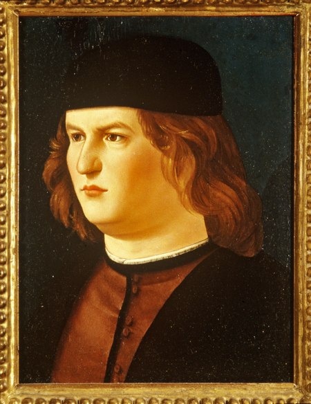 Bust portrait of a young man wearing a cap.