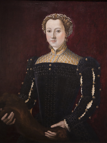 Portrait of a woman from the waist up a holding a weasel.